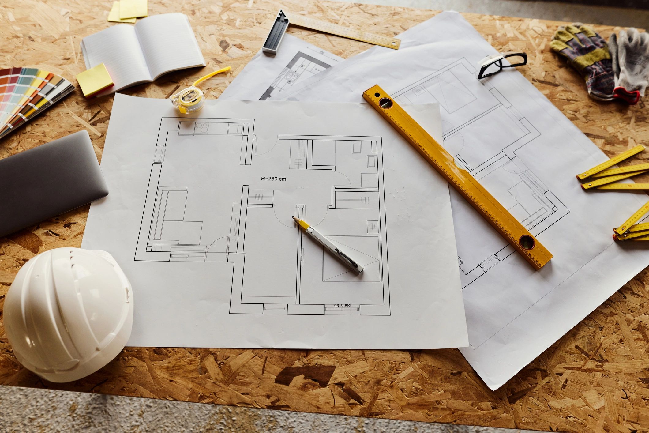 Construction blueprint and tools on a work surface